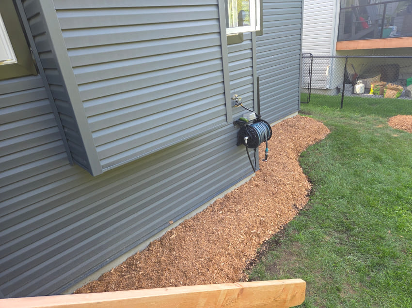 Mulch installation along house